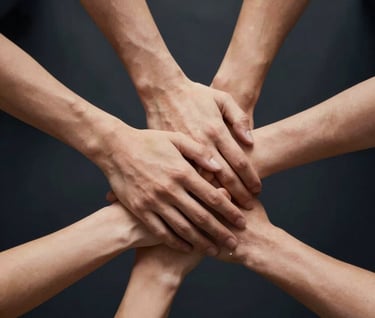 A symbolic image of hands coming together in unity. Professional studio lighting with a dark #1A1C20 backdrop and warm gold #A88B57 rim lighting on the hands.