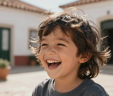 Close-up lifestyle photography of a child laughing, hair caught in the wind. Sunny Portuguese courtyard background. Soft charcoal and terracotta tones in the surroundings. Cinematic lighting.