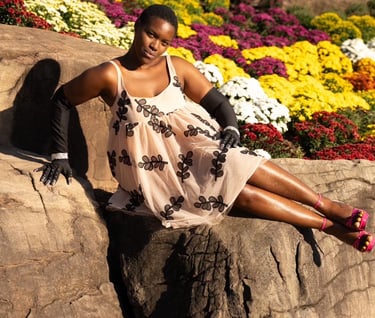 Woman posing in front of fall flowers 