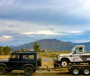a land rover with a flatbed trailer attached to it