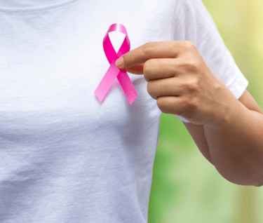 a women holding pink ribbon 🎗 