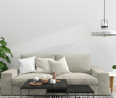 a room with Creem color sofa and table and lamp