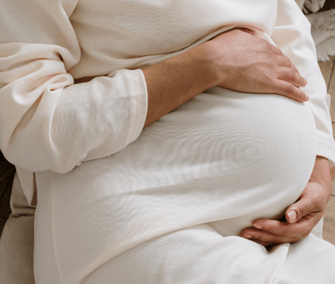 a pregnant women wearing white t-shirt 