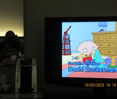 Girl sitting on a bed in the mirror watching cartoons