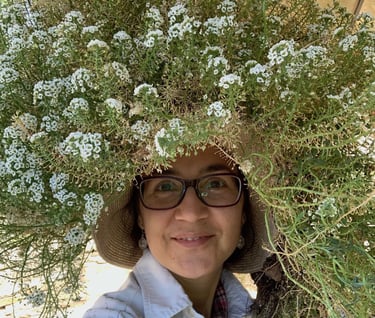 Katrina with a huge spray of alyssum flowers on top of her head