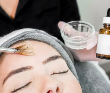a woman receiving a chemical peel with a fan brush