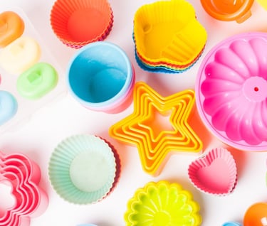 a variety of colorful plastic cupcakes and cake pans