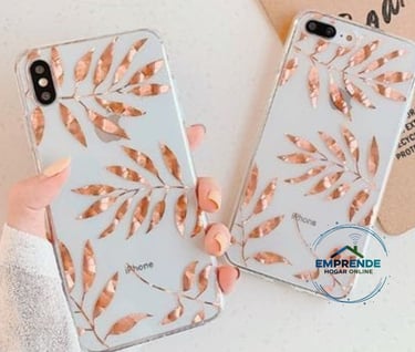 a woman holding a phone case with a rose gold leaf design
