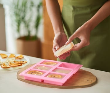 a woman in a green apron is holding a slice of cheese