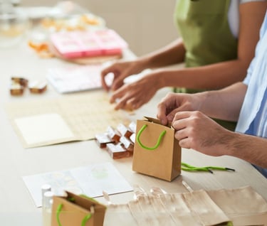 a man and woman are making a paper bag