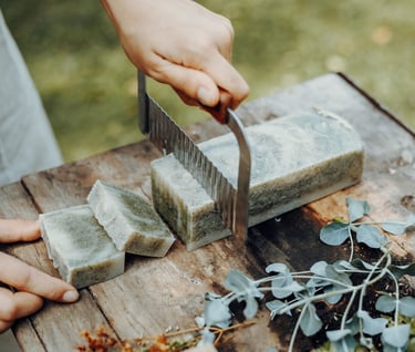 a person cutting a block of soap with a knife