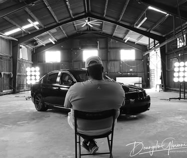 a man sitting in a chair in a garage