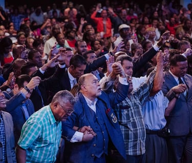 a crowd of people standing and praying
