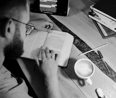 a man sitting at a desk with a cup of coffee