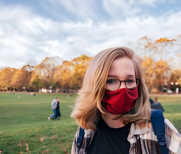 Woman with a red face mask standing in a park, representing the diverse global opportunities