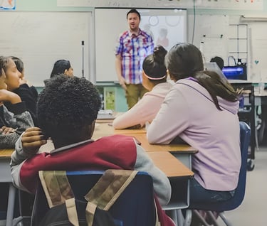 Teacher addressing students in classroom, demonstrating Admit 360's online test preparation