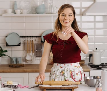 a woman in a red shirt is holding a rolling pinwheel