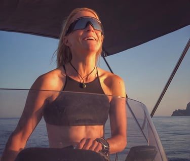 Girl driving power boat in the evening sun