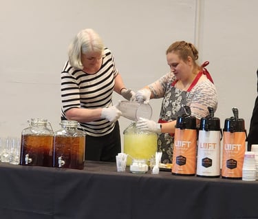 Ashley and Envisions staff Becky providing drink service.