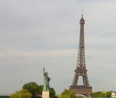 a view of a city with a tower in the Paris background
