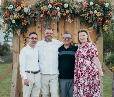 a family posing for a photo in front of a wooden door