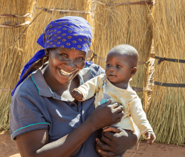 a woman in a blue shirt and a baby in a blue shirt