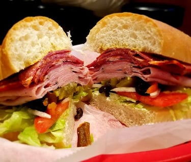 a Hogans Great Sandwich with meat and vegetables on a basket