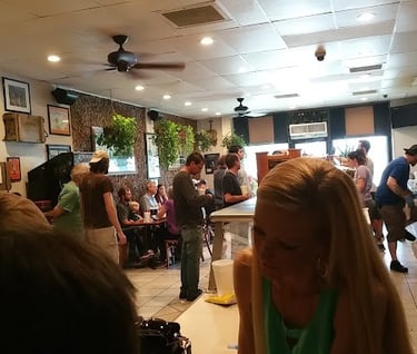 people standing in Hogan's Great Sandwich restaurant