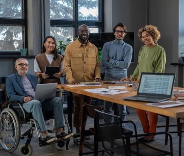 Employees gather around a work table