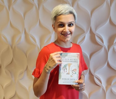 Dr. Malini Karani holds the newly designed cover for Let there be calamities by Kiran Java