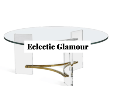 a round, modern lucite coffee table with brass details