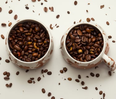 two cups of coffee beans and coffee beans