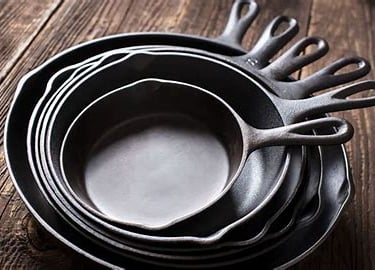 “Different cast iron skillet sizes displayed together