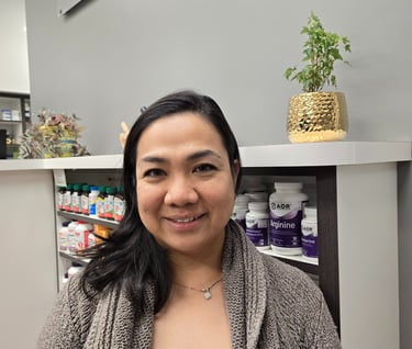 A woman smiling with medium length black hair