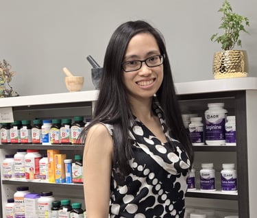 A woman with long black hair and glasses