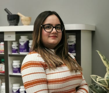woman with dark hair and glasses smiling