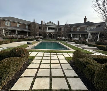a large pool with a pool and a house in the background