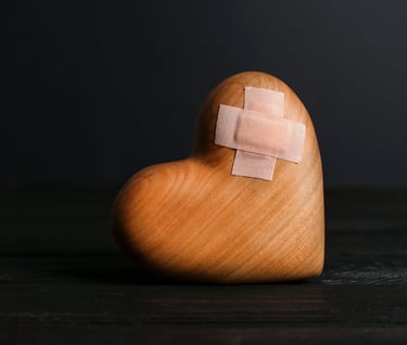 Wooden heart with a bandaid