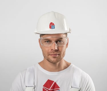 a man wearing a white hard hat and safety glasses