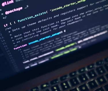 Close-up of PHP backend code and syntax highlighting on a laptop screen.