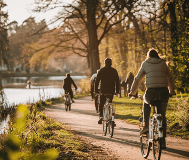 a group of people riding bikes down a path