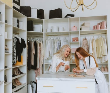 two women in white robes standing in a closet