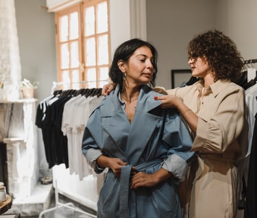 a woman in a blue robe is standing in front of a fireplace