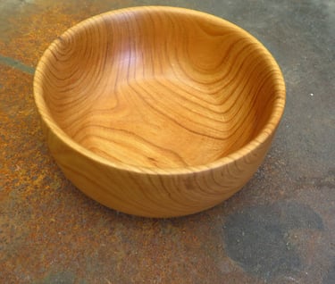 a wooden bowl with a wooden bowl on the floor