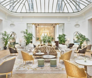 Palm Court Restaurant – A sophisticated dining area under a stunning glass ceiling with lush greener