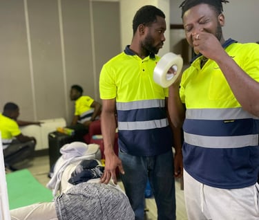 A team of four professional movers in yellow high-visibility polos with reflective stripes and "Safe