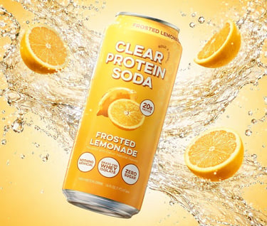 Frosted Lemonade Clear Protein Soda can with fresh lemon slices and splashing liquid on yellow background.