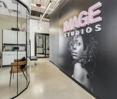 Modern salon interior at Image Studios featuring luxury private beauty suites and sleek glass walls.