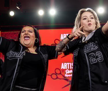 SportClips hairstylists performing on stage during the National Huddle 2024 Fans First artistic team presentation.