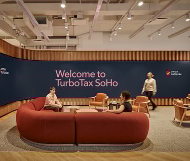 a group of people sitting around a couch in a room